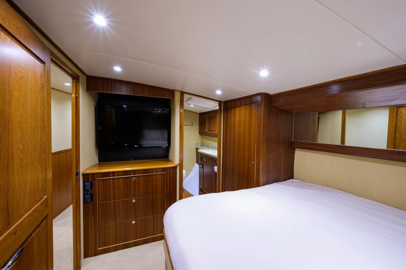 a bedroom with a tv and a bed aboard FLYING J Yacht for Sale