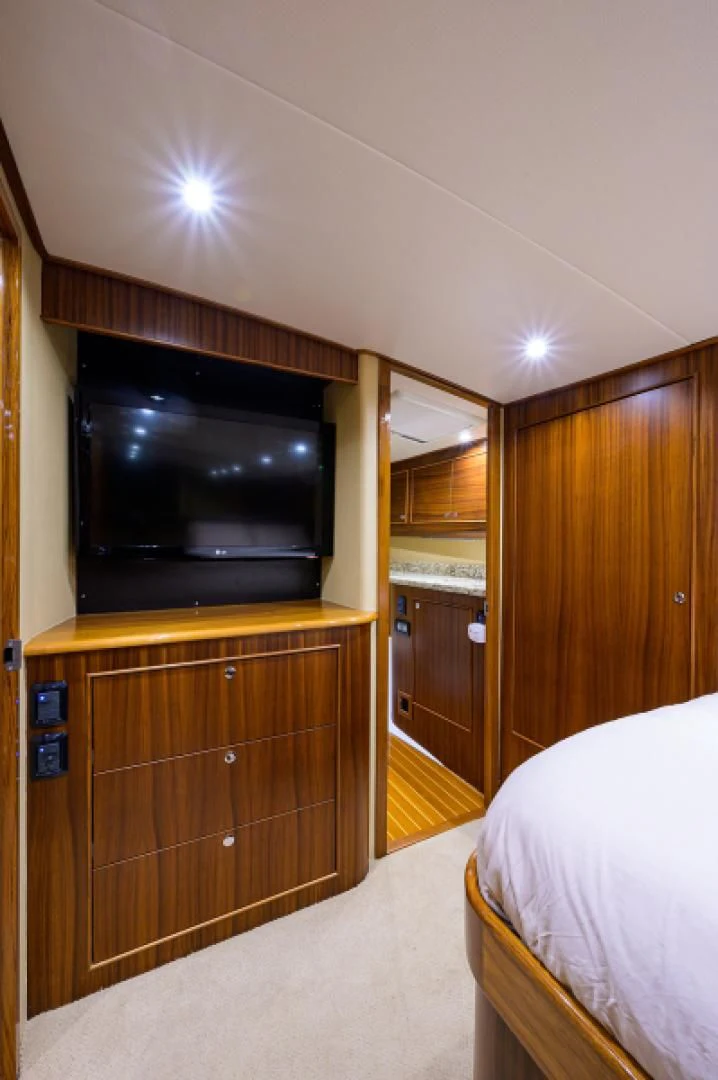 a bedroom with a bed and a television aboard FLYING J Yacht for Sale