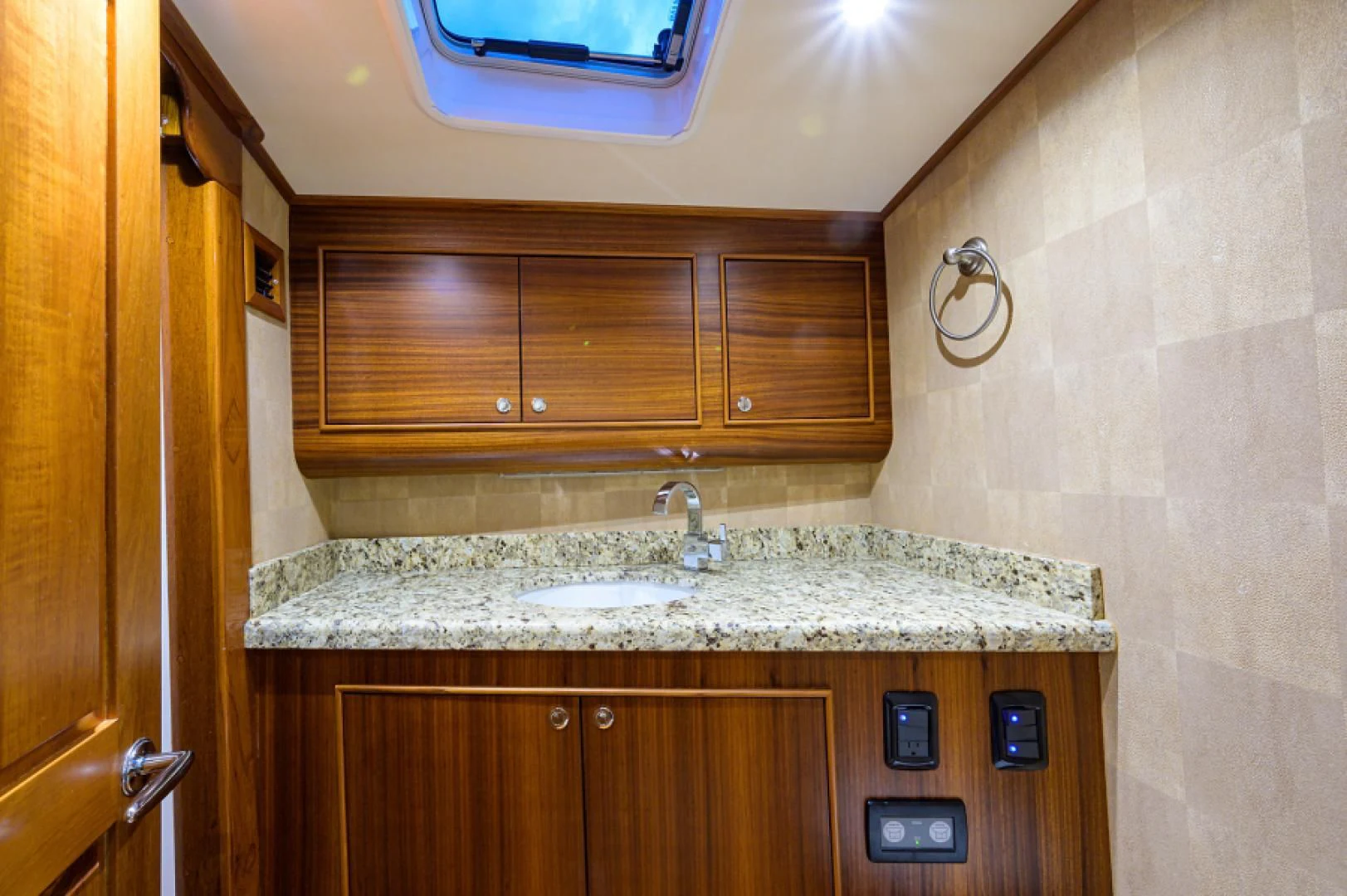 a kitchen with wooden cabinets aboard FLYING J Yacht for Sale