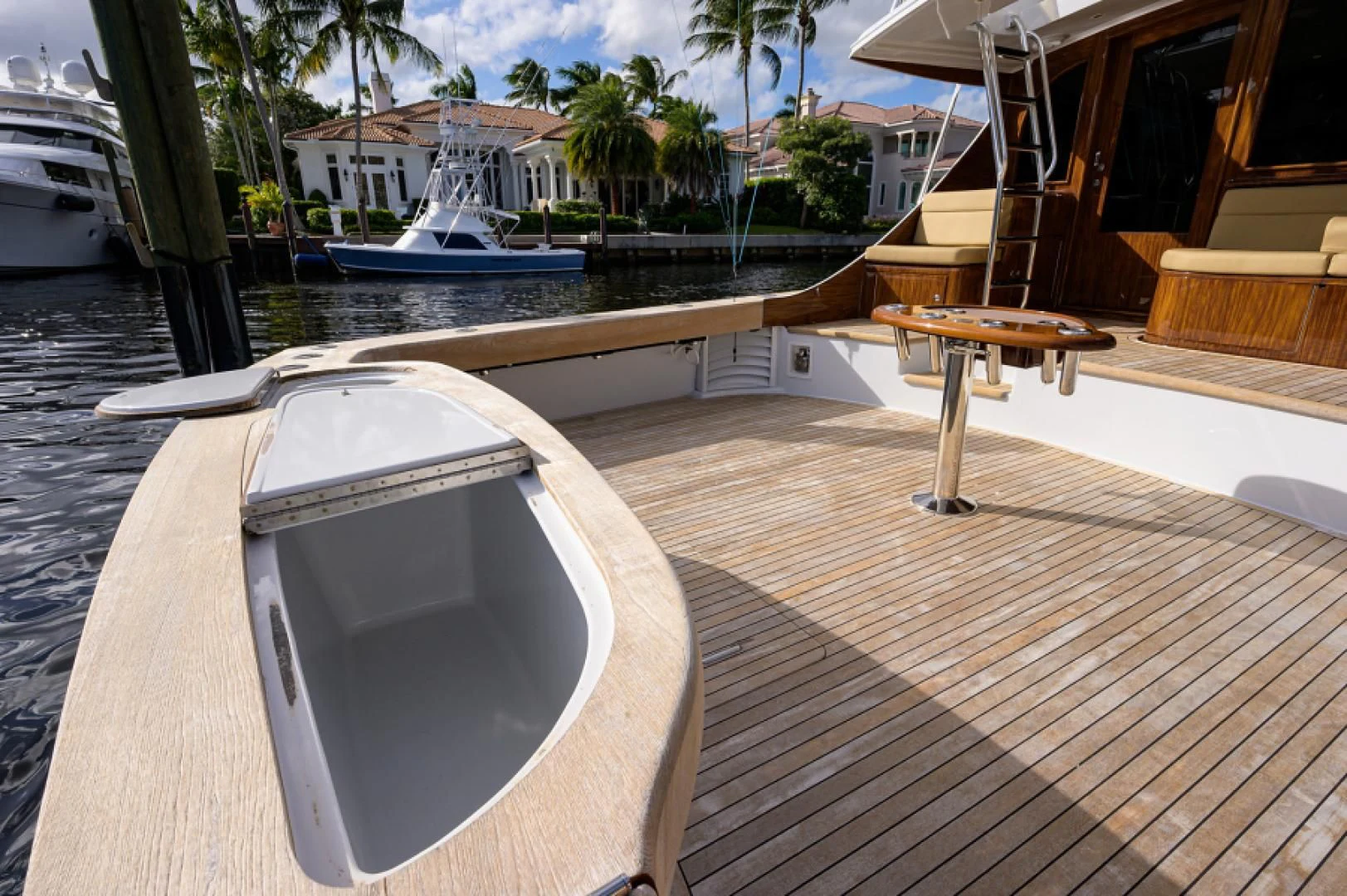 a deck with a table and chairs aboard FLYING J Yacht for Sale