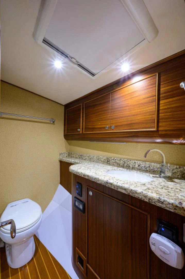 a bathroom with a toilet and sink aboard FLYING J Yacht for Sale