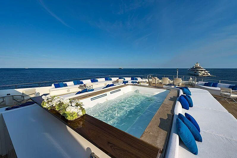 a large swimming pool with a view of the ocean and the ocean aboard MARQUISE Yacht for Sale
