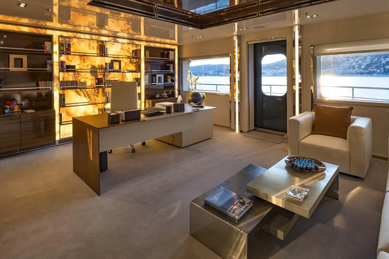 a living room with a large book shelf and a coffee table aboard MARQUISE Yacht for Sale