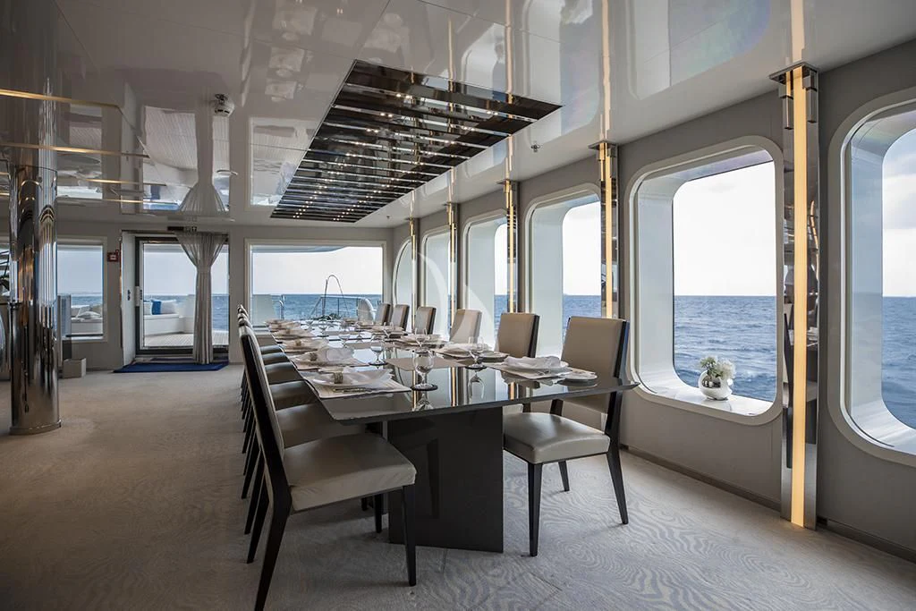 a large room with a table and chairs aboard MARQUISE Yacht for Sale