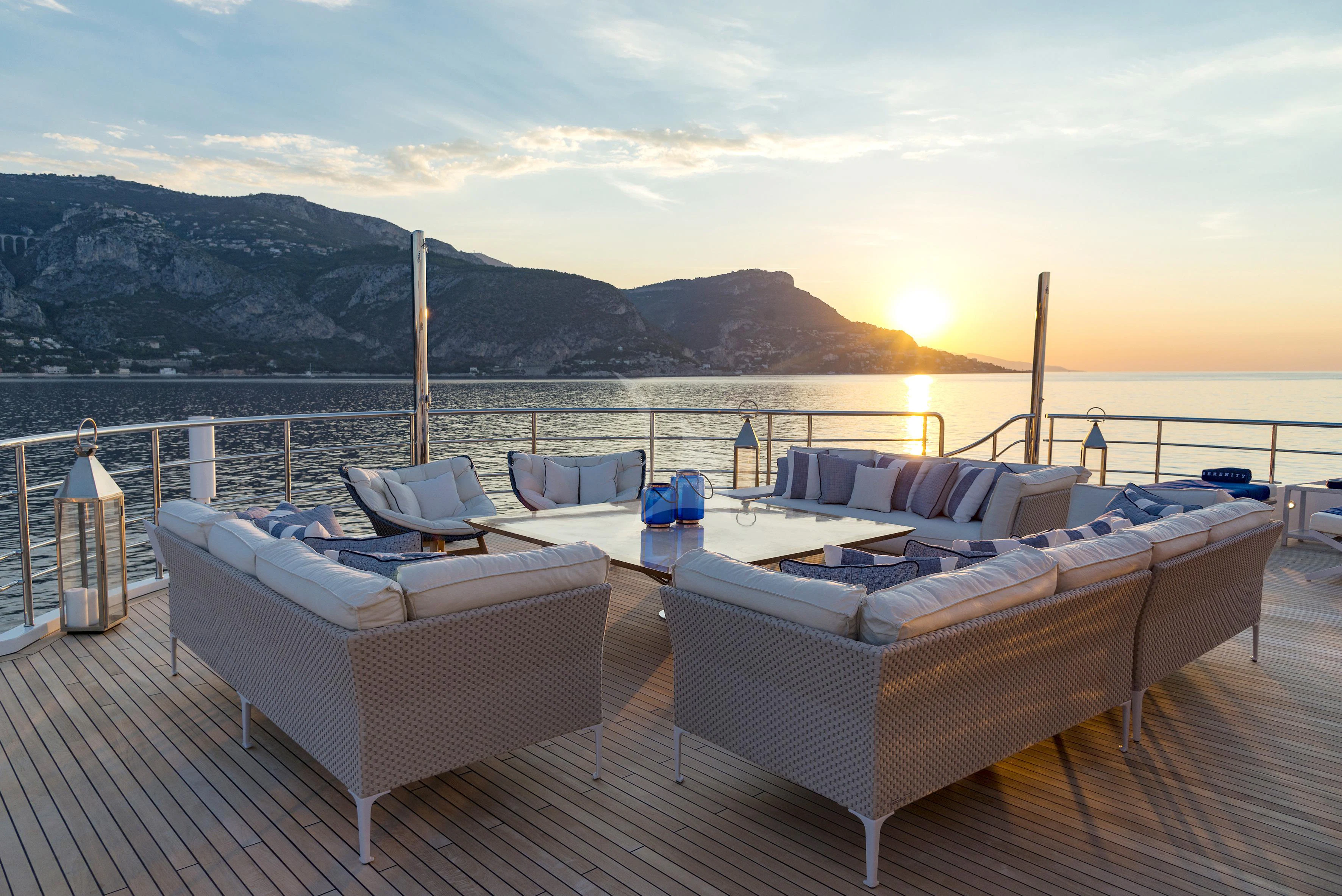 a deck with a view of the mountains and the ocean aboard MARQUISE Yacht for Sale