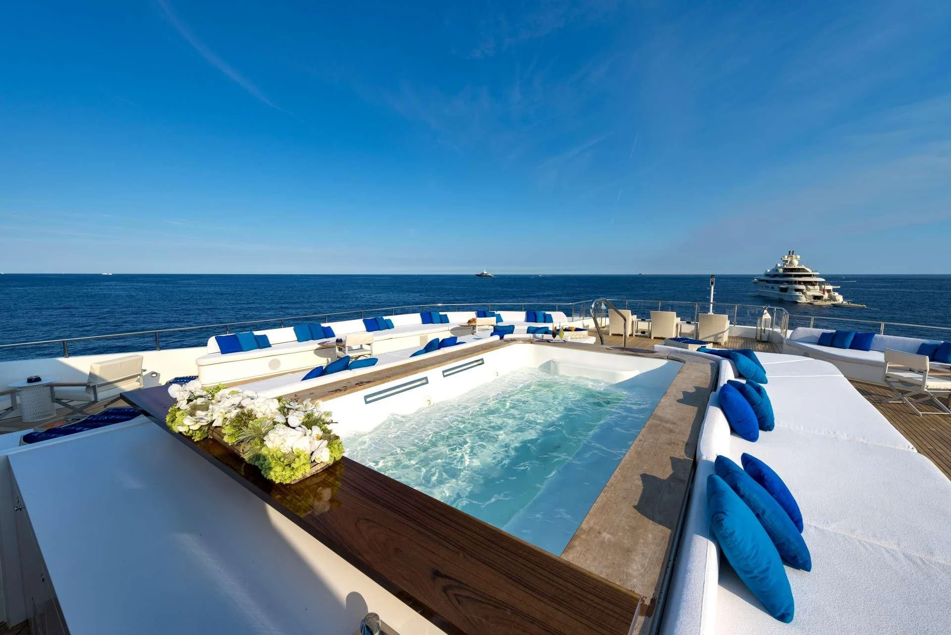 a rooftop view of a pool and a deck with a view of the ocean and boats aboard MARQUISE Yacht for Sale