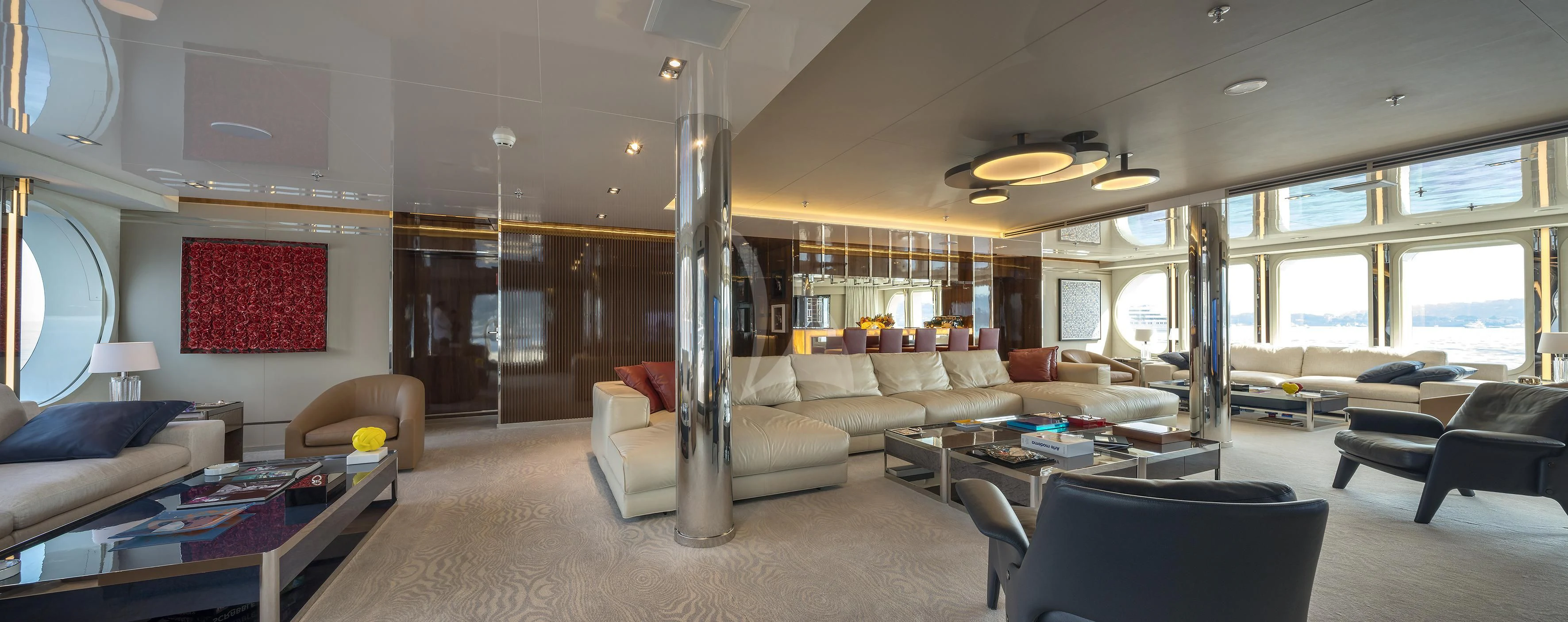 a large living room with a large glass table and a large window aboard MARQUISE Yacht for Sale