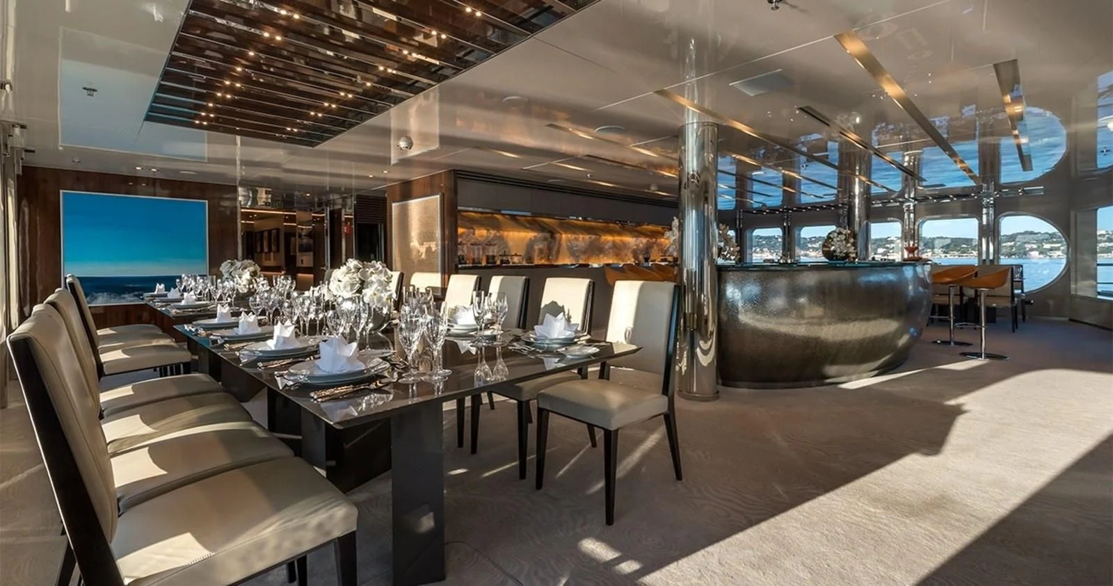 a room with a table chairs and a fireplace aboard MARQUISE Yacht for Sale