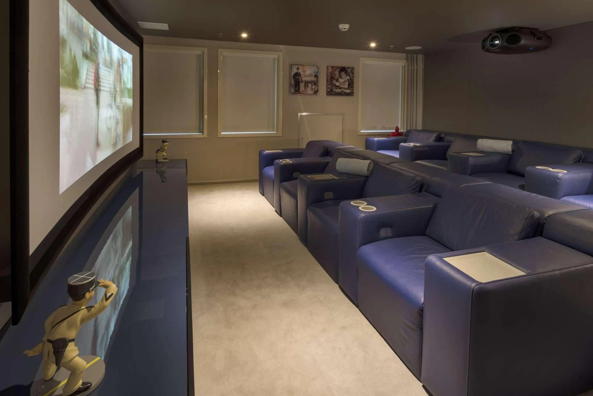 a living room with blue couches and a television aboard MARQUISE Yacht for Sale