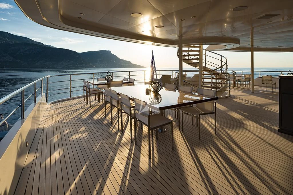 a deck with a table and chairs on it aboard MARQUISE Yacht for Sale