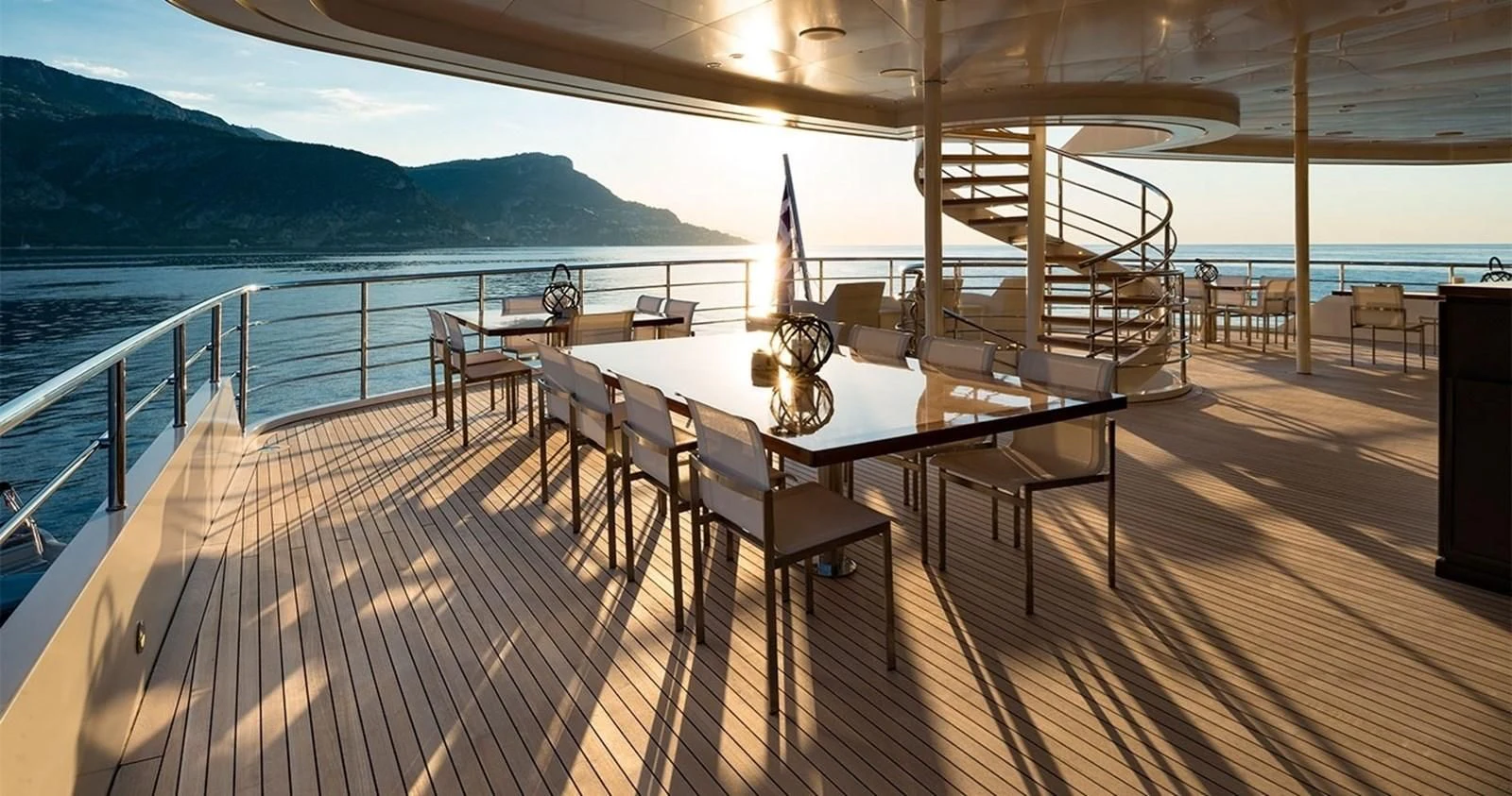 a deck with a table and chairs on it aboard MARQUISE Yacht for Sale
