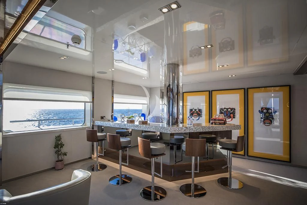 a room with tables and chairs aboard MARQUISE Yacht for Sale