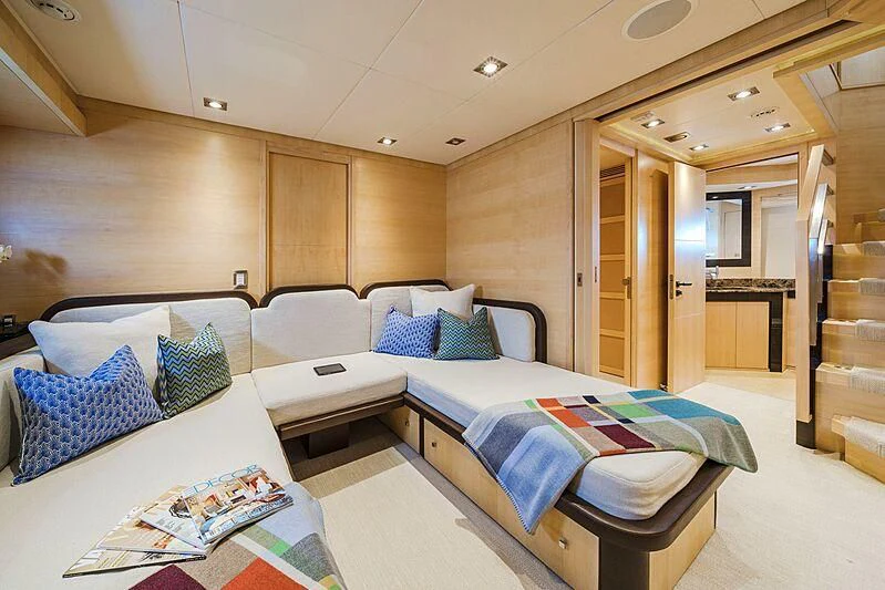 a room with a bed and a desk aboard KJOS Yacht for Charter