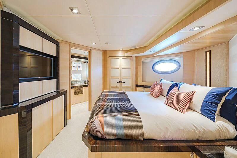 a bedroom with a bed and a tv aboard KJOS Yacht for Charter