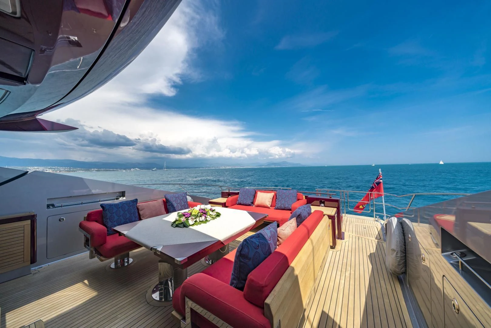 a deck with a view of the ocean and the ocean aboard KJOS Yacht for Charter