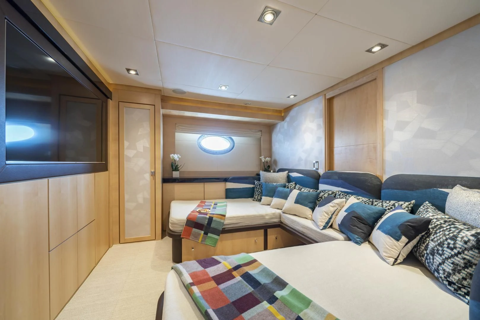 a room with a bed and a couch aboard KJOS Yacht for Charter