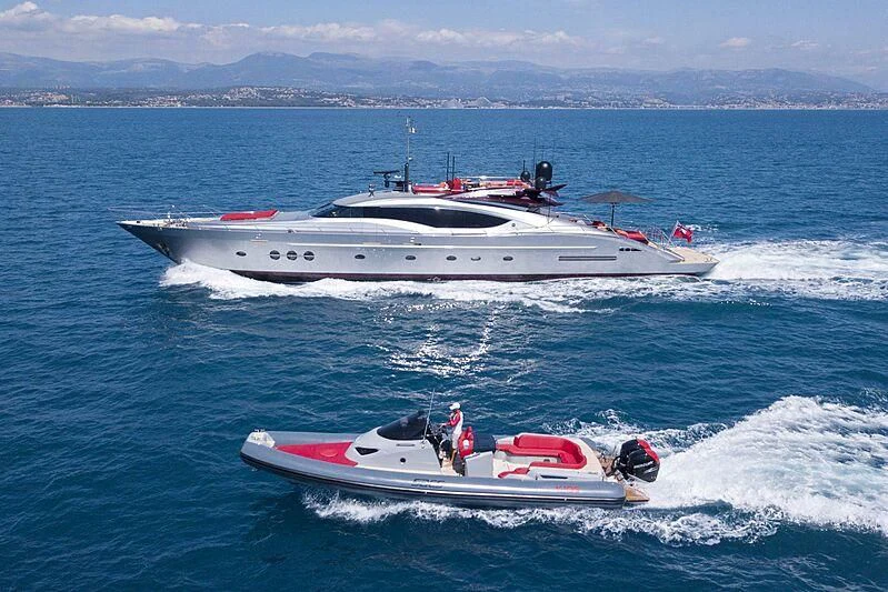 a boat with a motor boat aboard KJOS Yacht for Charter