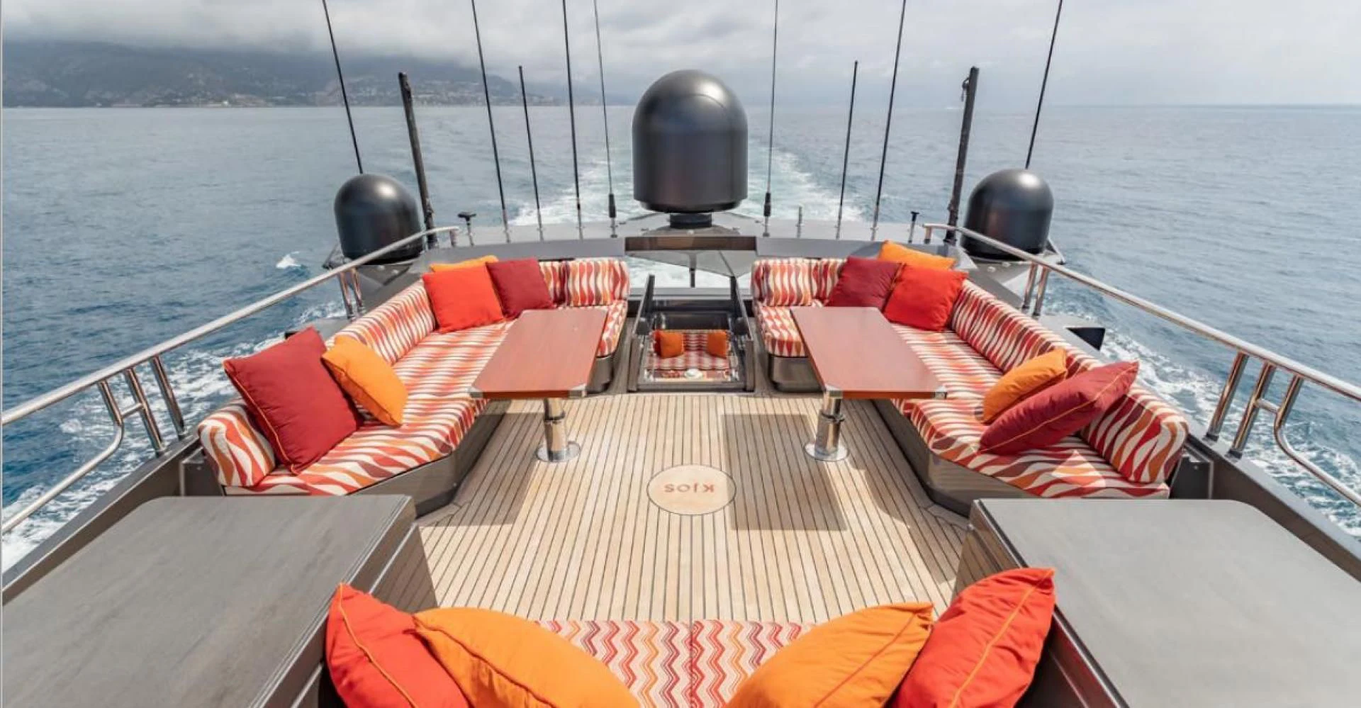 a deck with a deck and chairs on it aboard KJOS Yacht for Charter