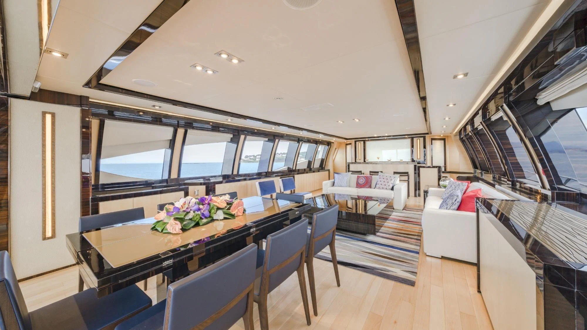 inside of a building with a table and chairs and a couch aboard KJOS Yacht for Charter