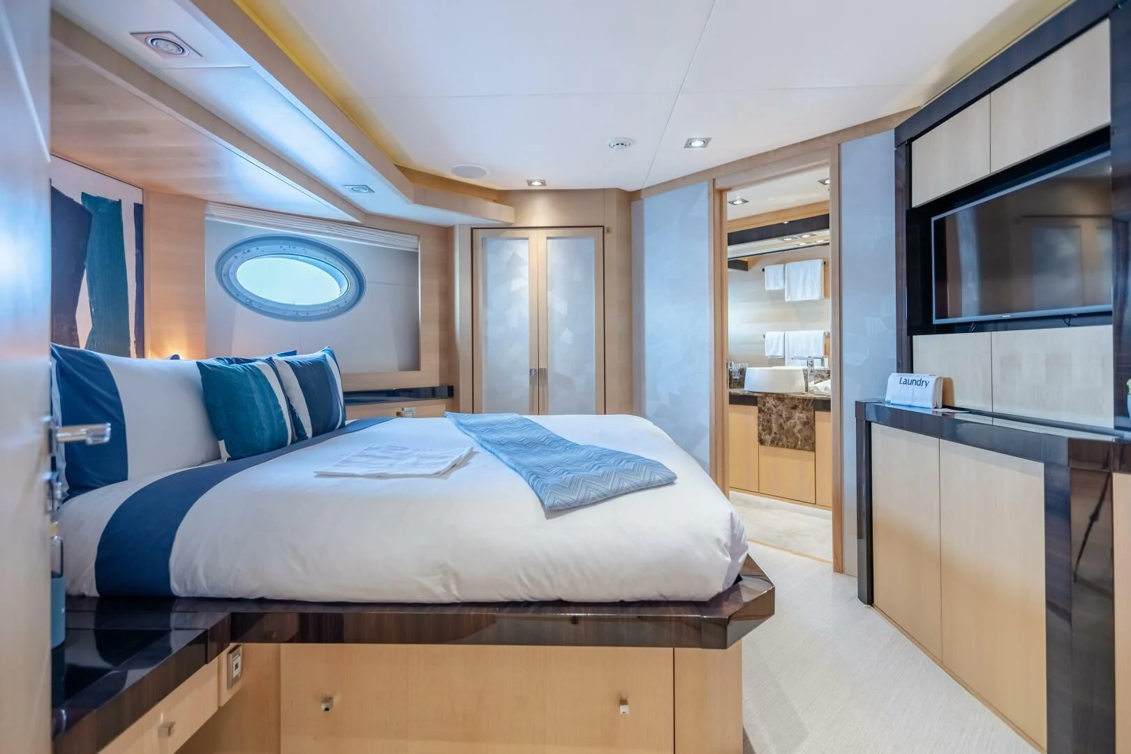 a room with a bed and a tv aboard KJOS Yacht for Charter
