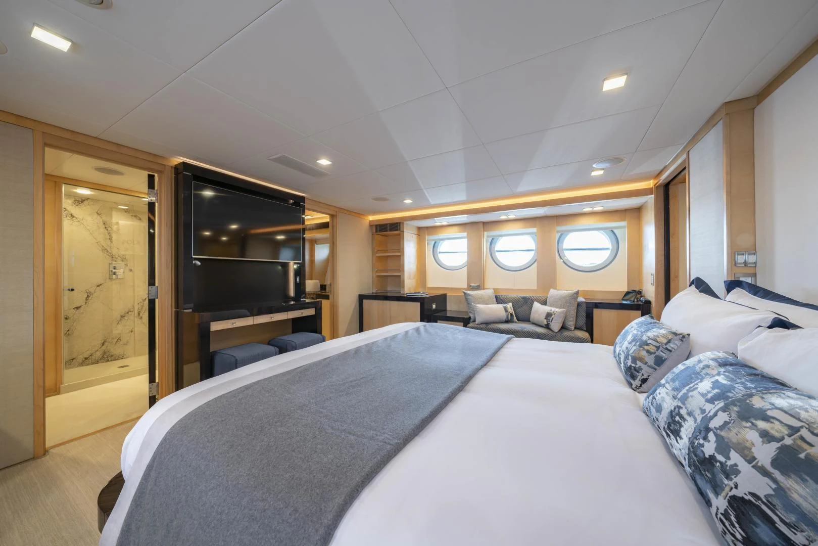 a bedroom with a bed and a mirror aboard KJOS Yacht for Charter