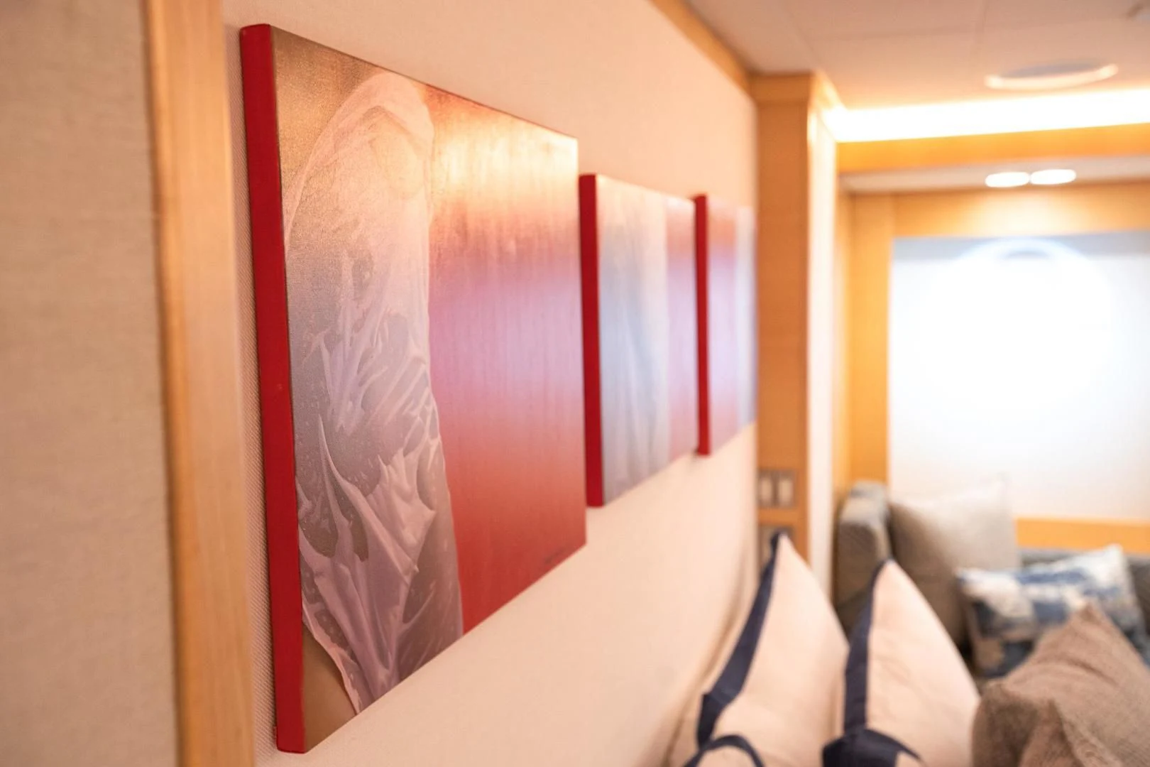 a room with a red wall aboard KJOS Yacht for Charter