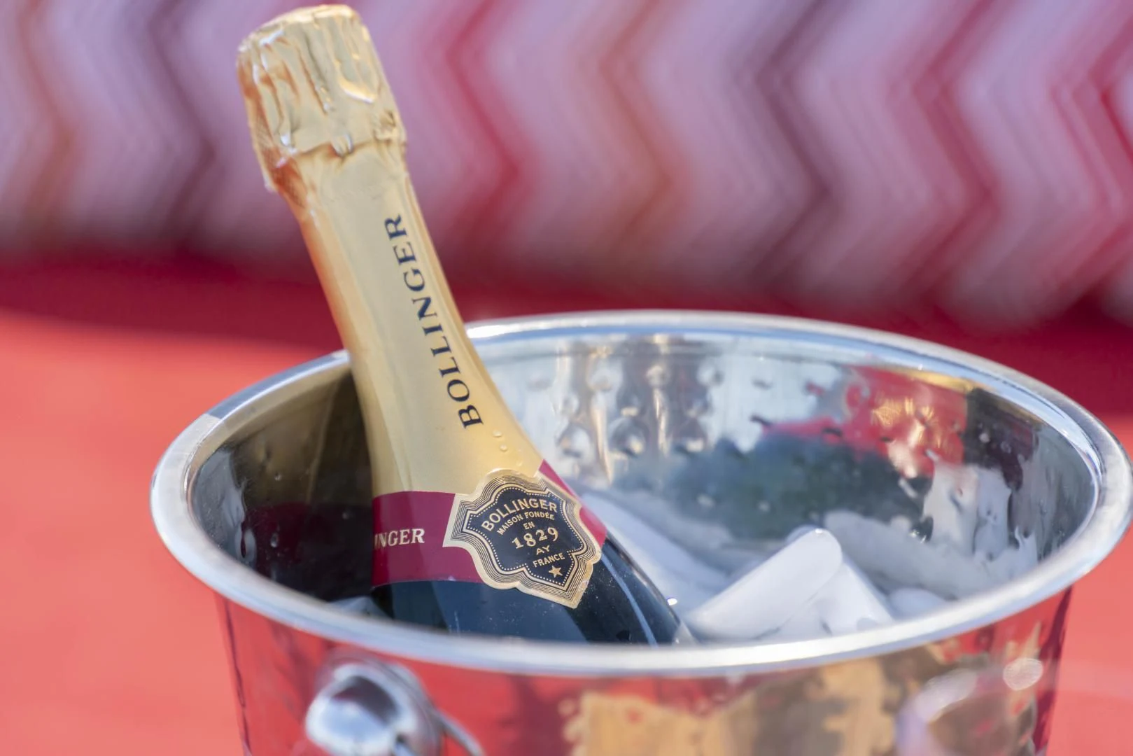 a hand holding a cigarette in a cup of liquid aboard KJOS Yacht for Charter