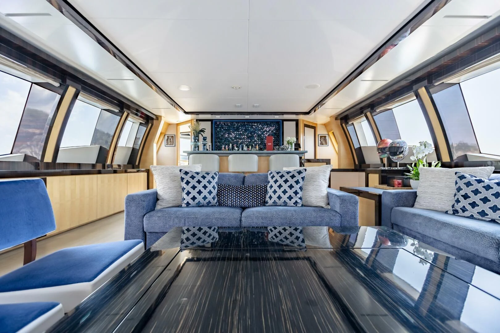 a living room with a large sofa aboard KJOS Yacht for Charter