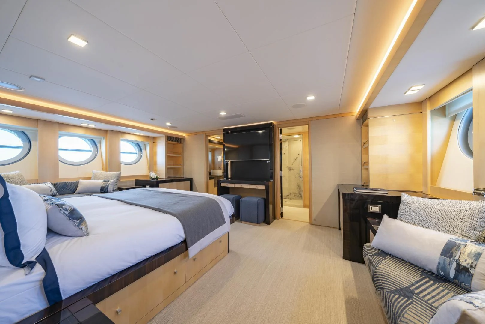 a large bedroom with a bed and a couch aboard KJOS Yacht for Charter
