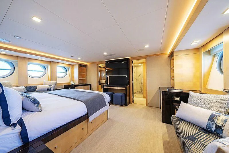 a large bedroom with a bed and a tv aboard KJOS Yacht for Charter