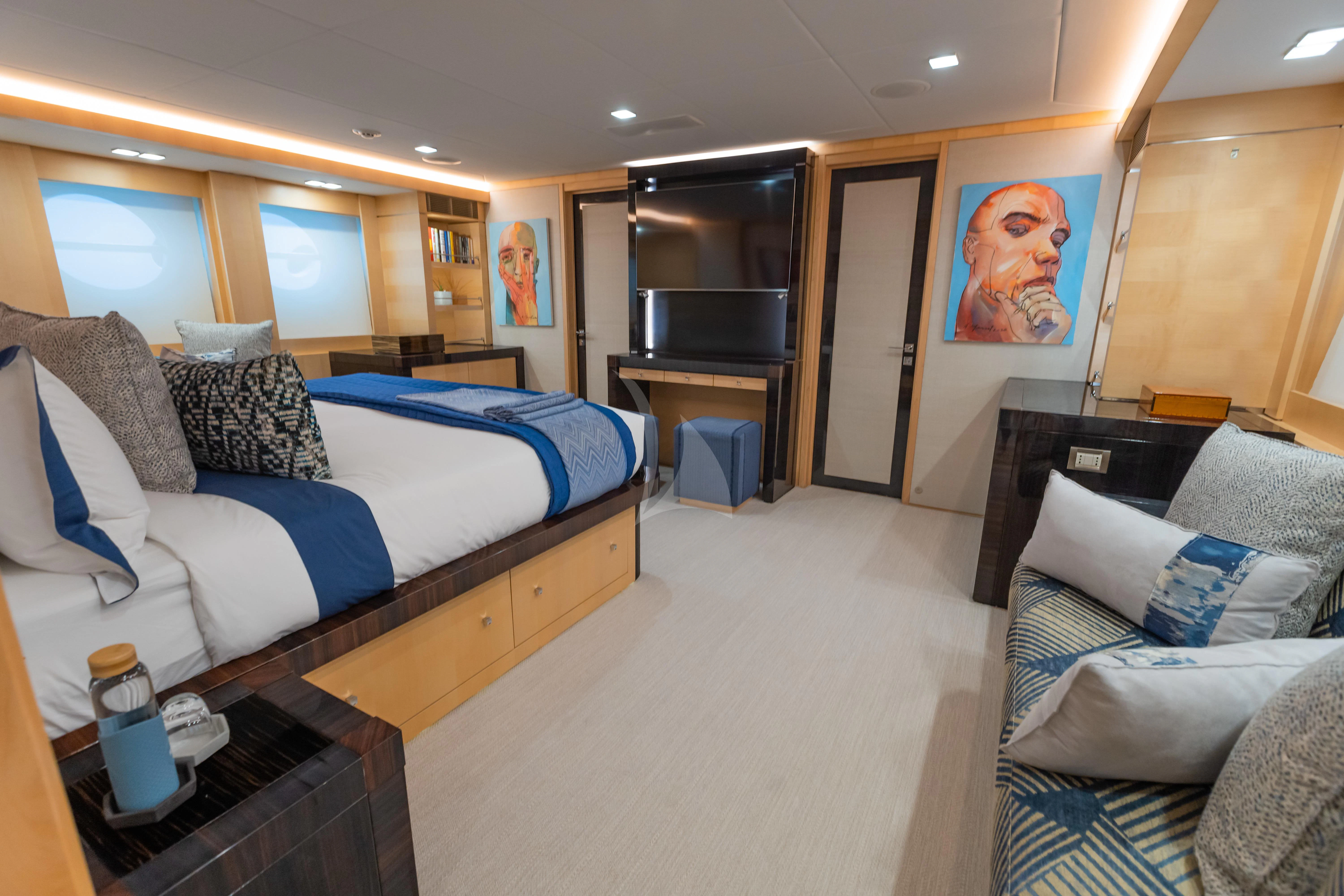 a bedroom with a bed and a couch aboard KJOS Yacht for Charter
