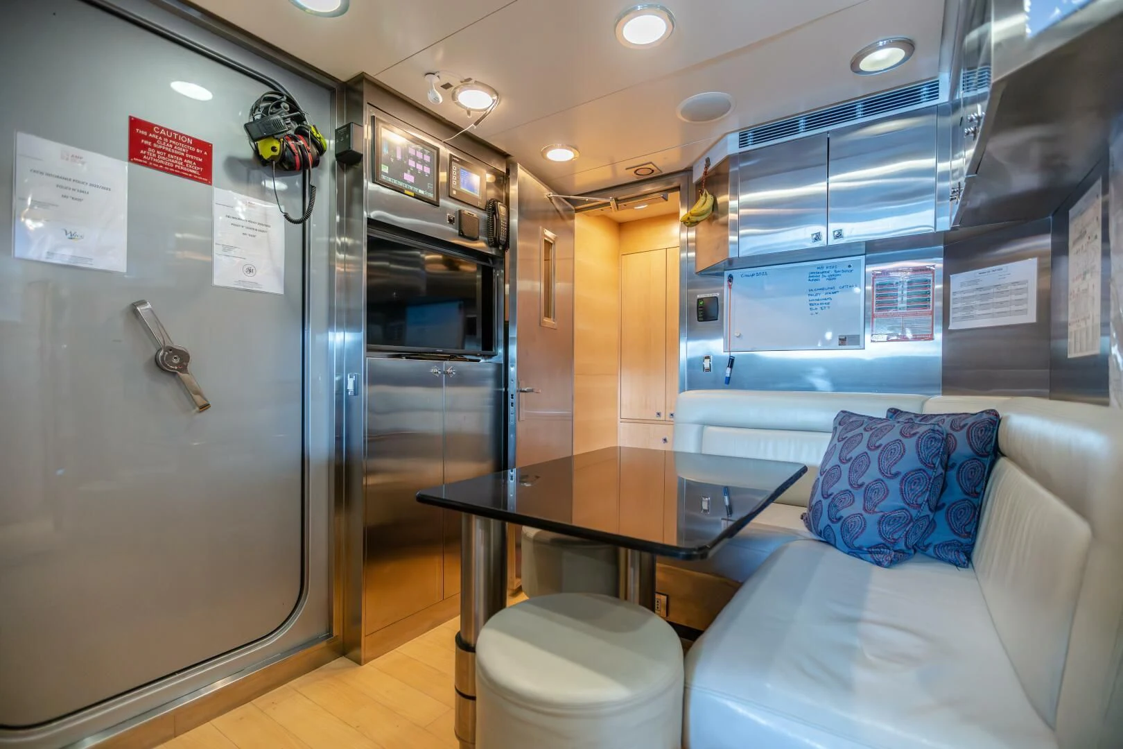 a room with a table and a couch aboard KJOS Yacht for Charter