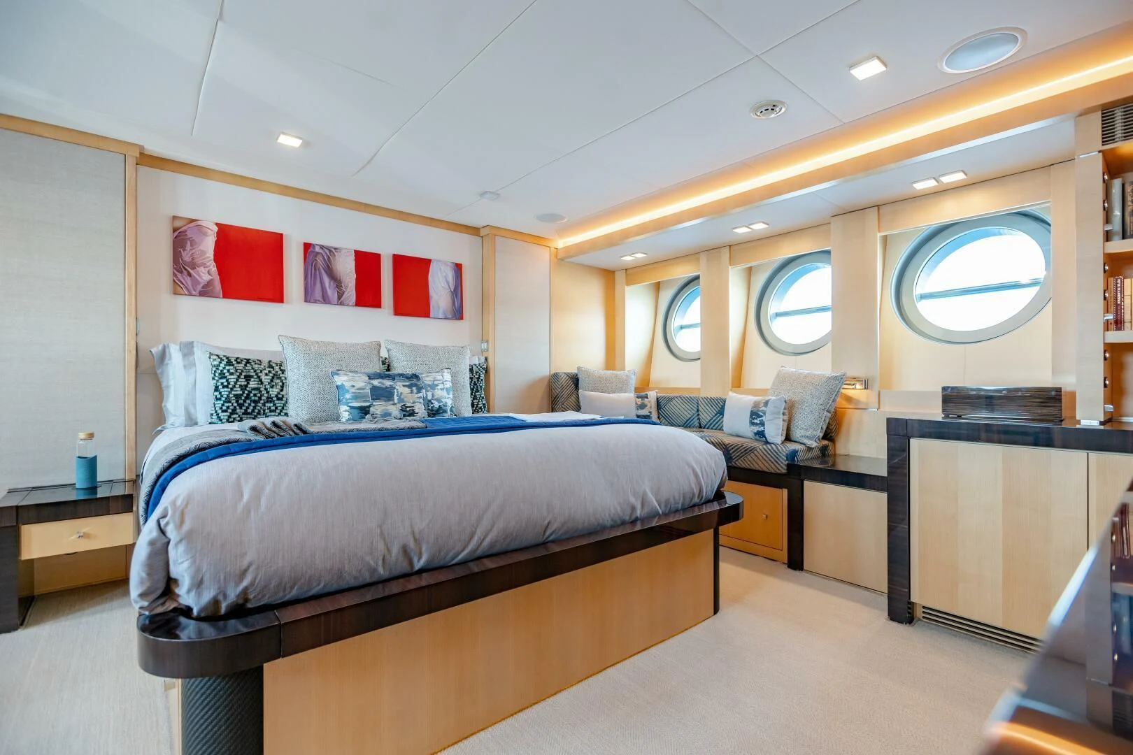 a bedroom with a bed and desk aboard KJOS Yacht for Charter