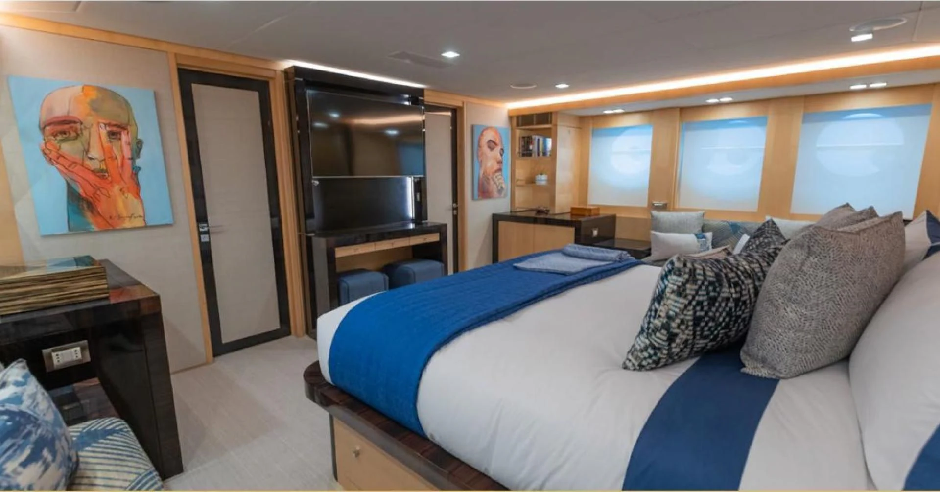 a bedroom with a bed and a desk aboard KJOS Yacht for Charter