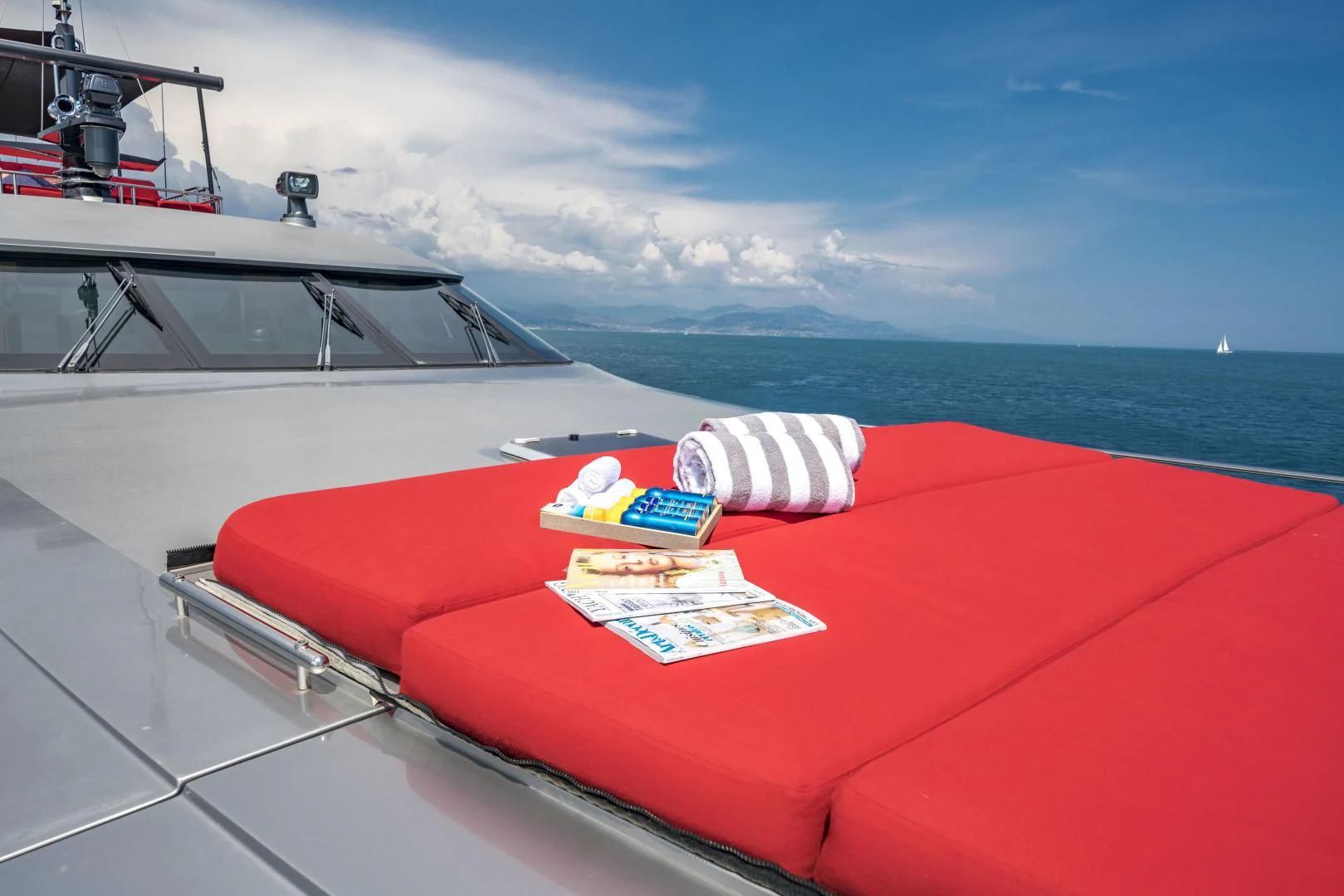 a red boat with a red cover and a red blanket on it aboard KJOS Yacht for Charter