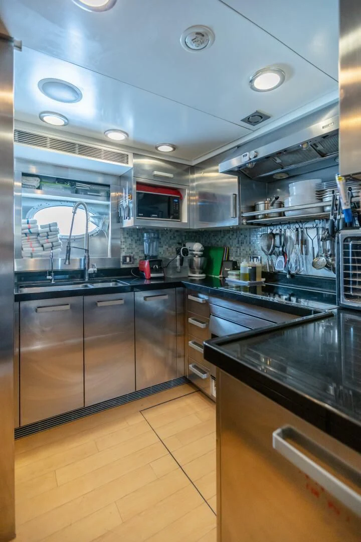 a kitchen with stainless steel appliances aboard KJOS Yacht for Charter