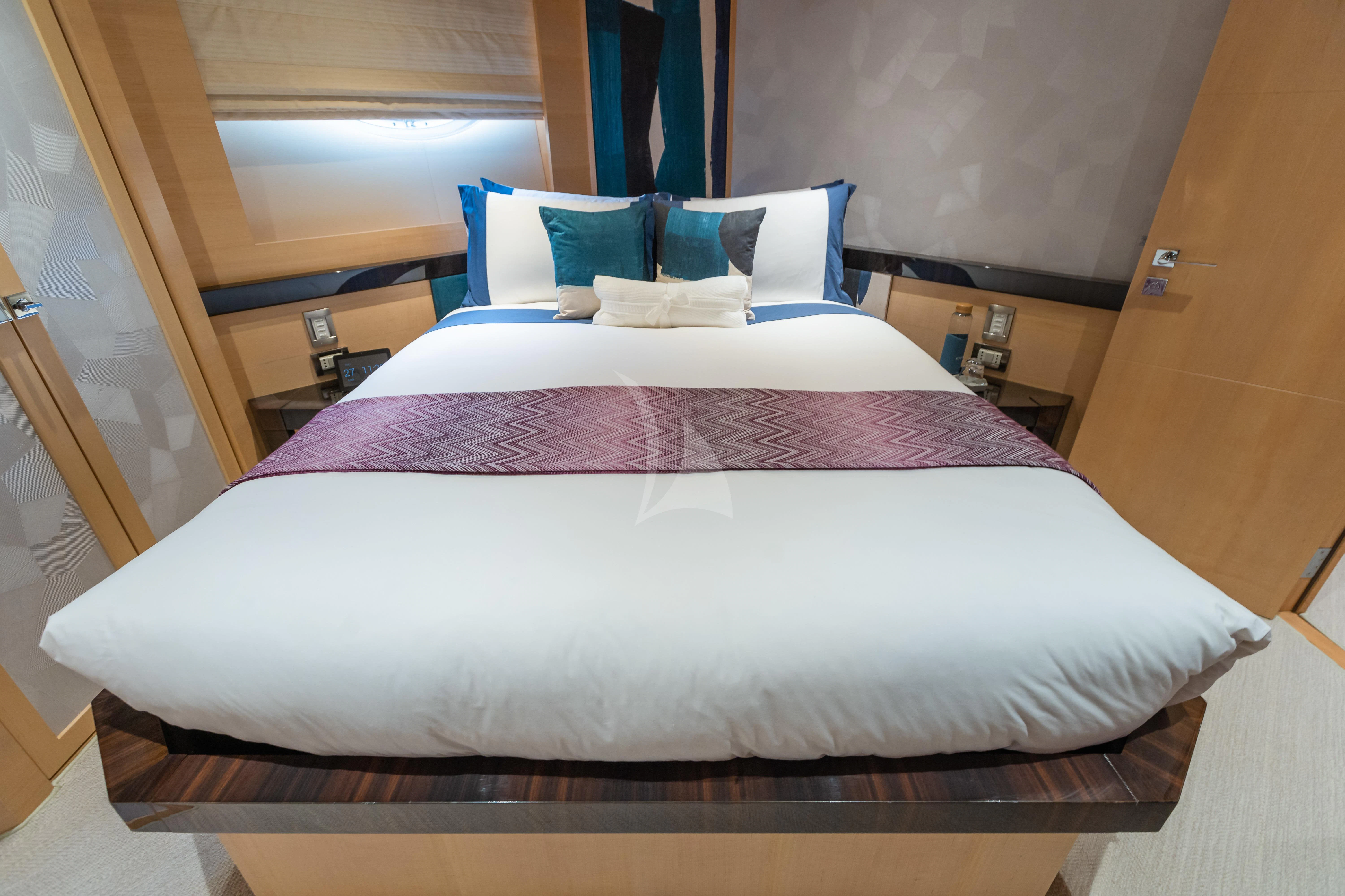 a bed with a white sheet aboard KJOS Yacht for Charter