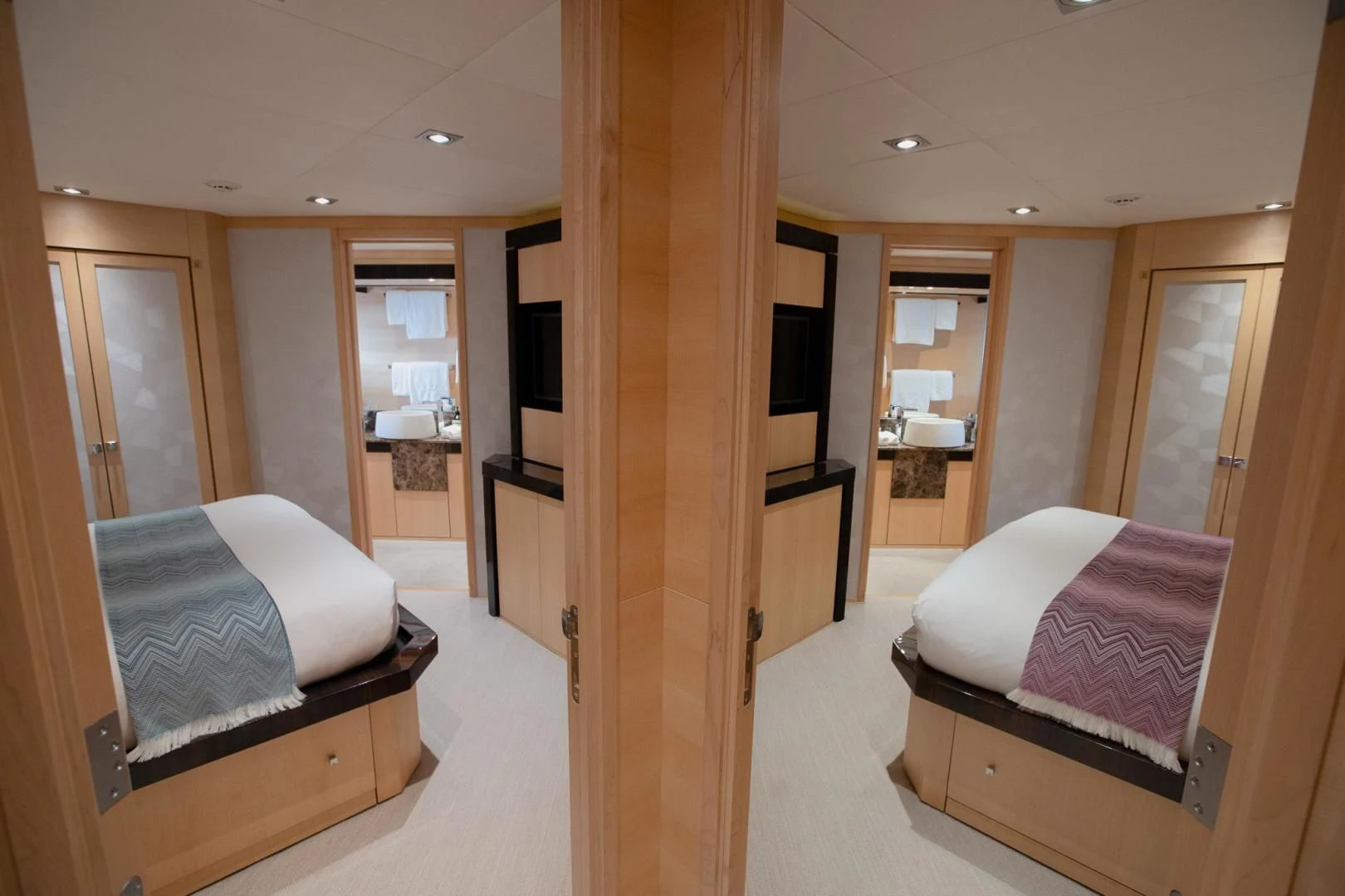 a room with a bed and a closet aboard KJOS Yacht for Charter