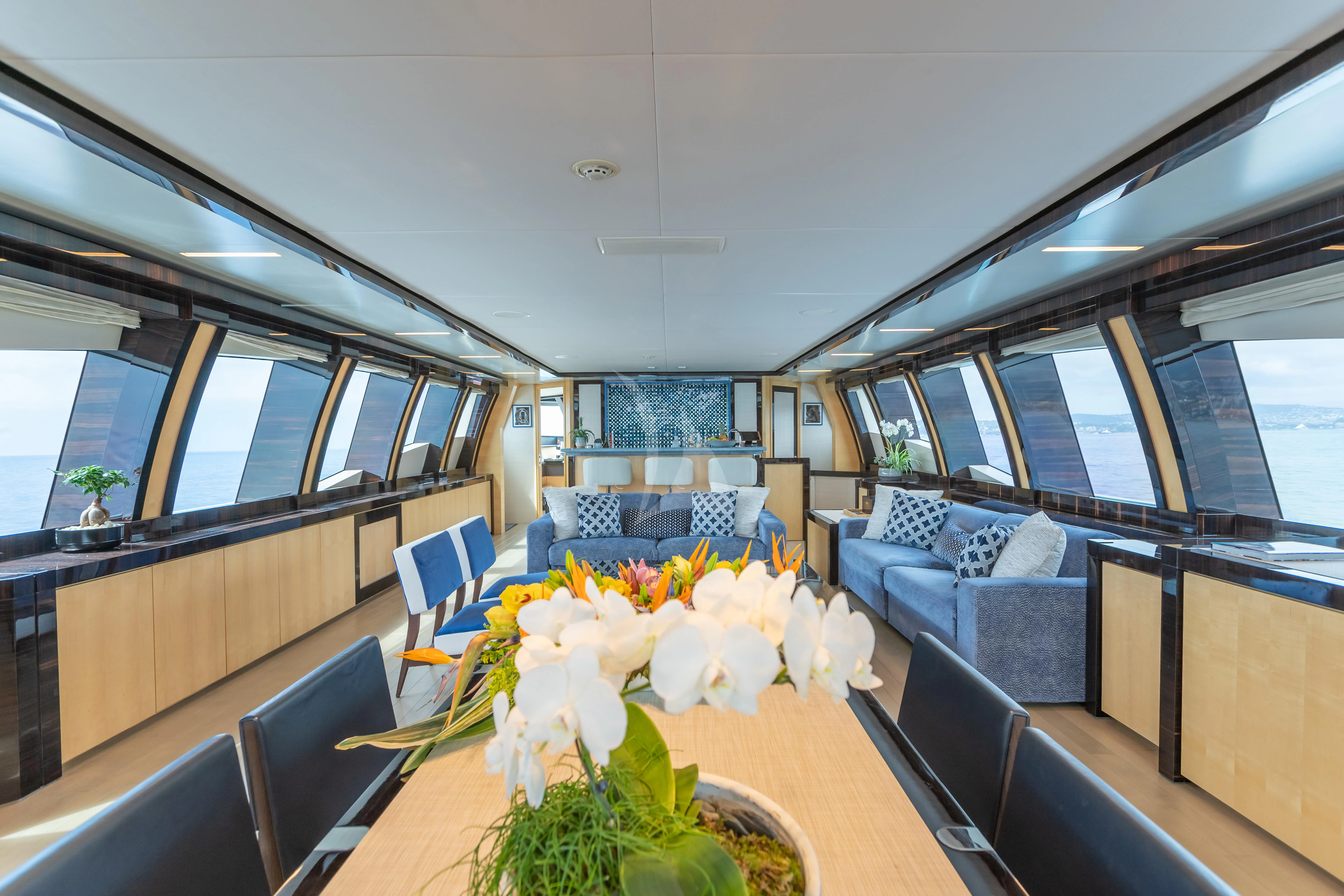 a room with a table and chairs aboard KJOS Yacht for Charter