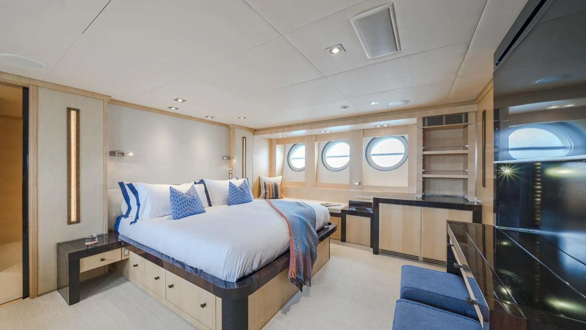 a room with a bed and a desk aboard KJOS Yacht for Charter