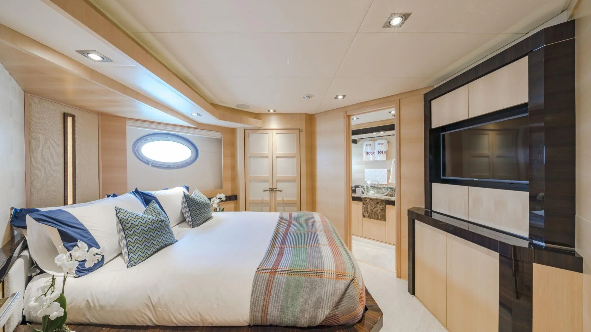 a bedroom with a bed and a tv aboard KJOS Yacht for Charter