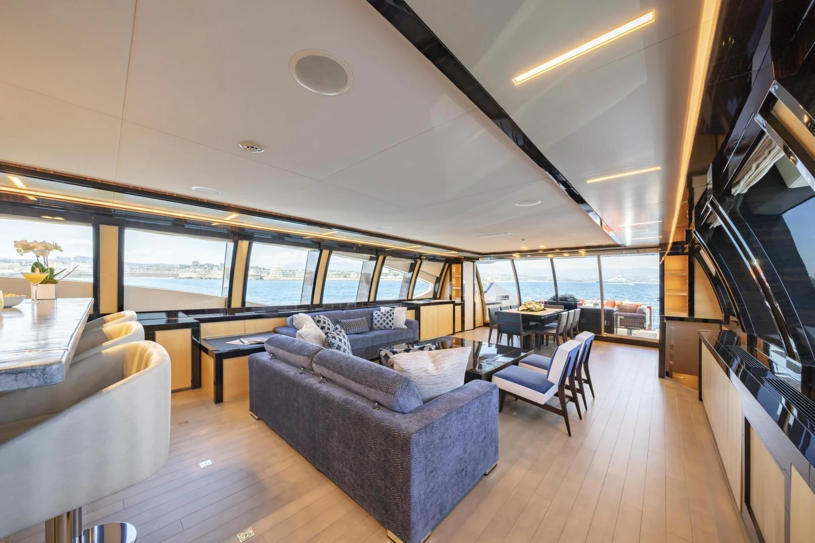 a living room with a large window aboard KJOS Yacht for Charter