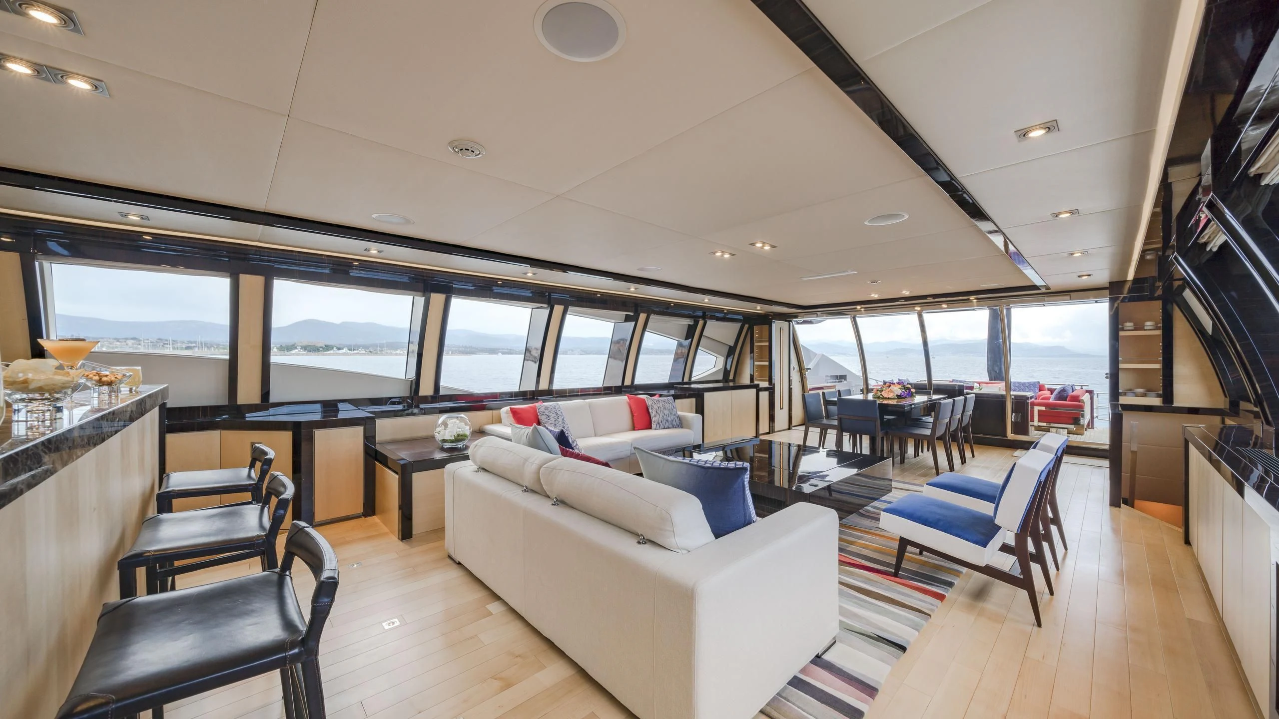 a room with a couch and a table and chairs aboard KJOS Yacht for Charter