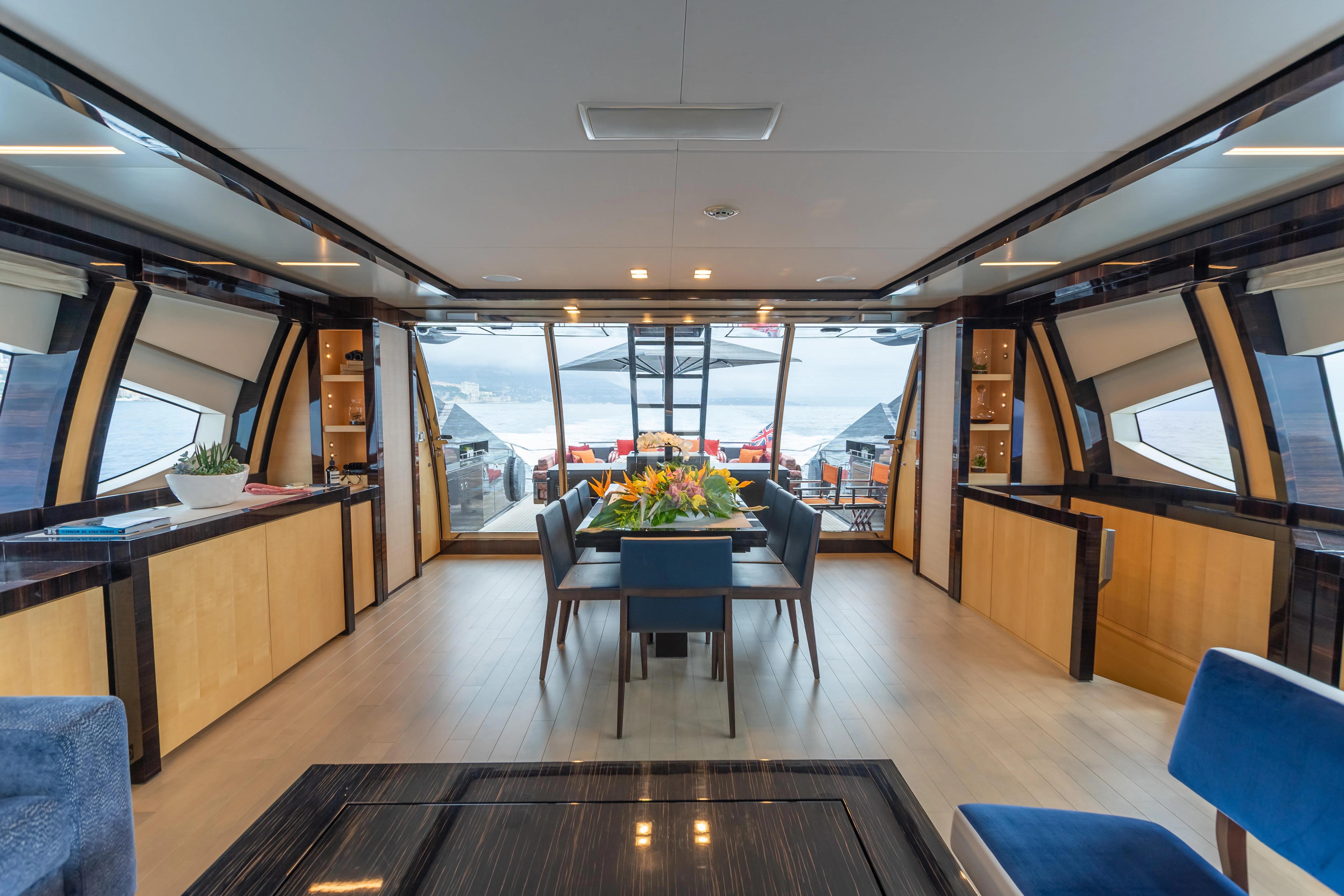 a room with a table and chairs aboard KJOS Yacht for Charter
