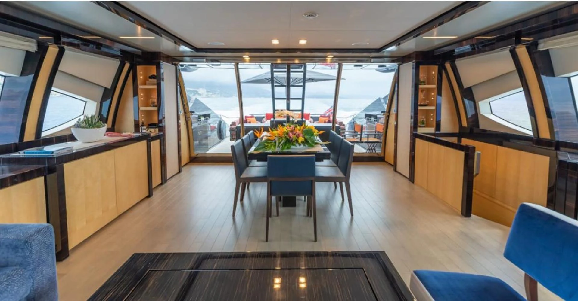 a room with a table and chairs aboard KJOS Yacht for Charter