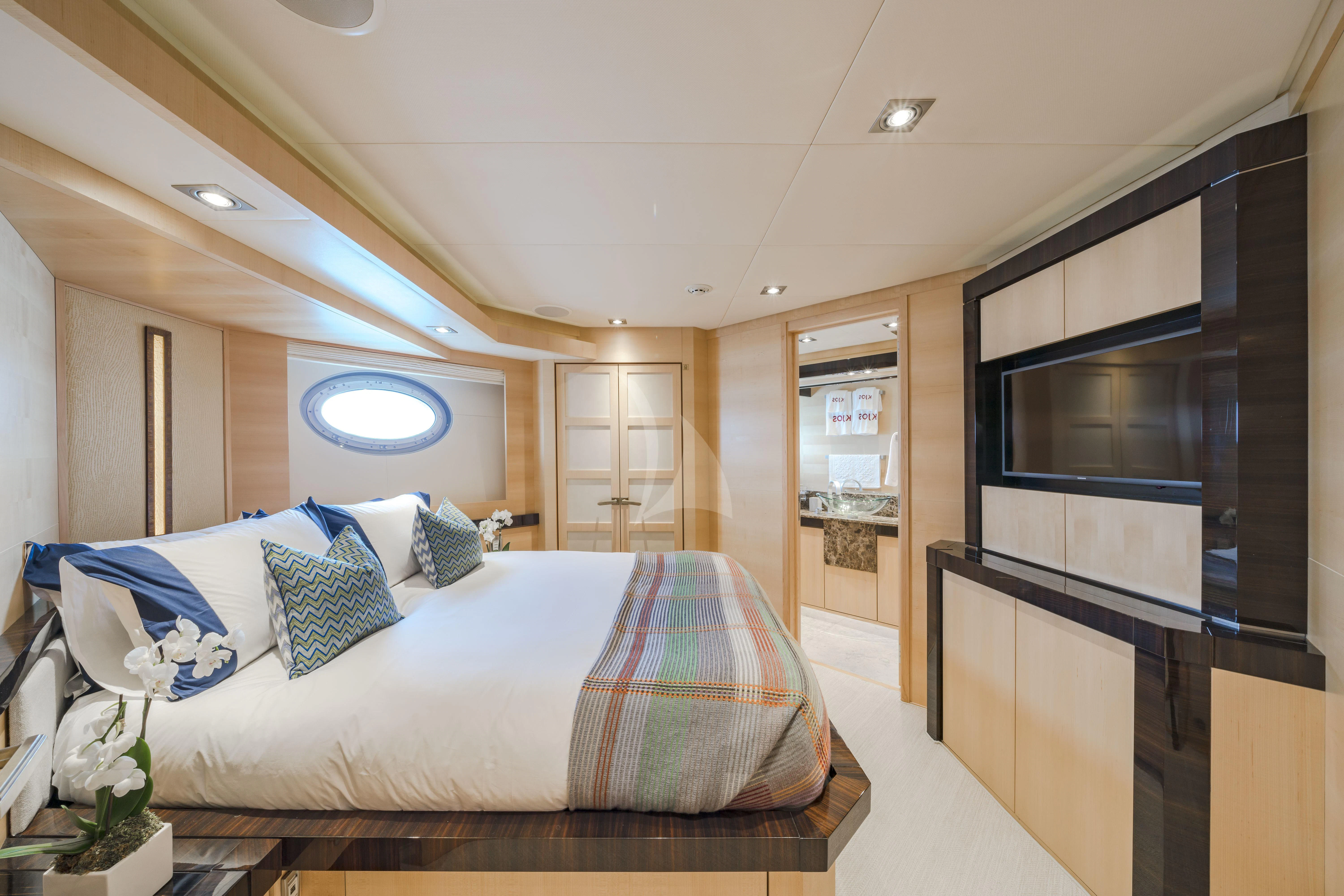 a bedroom with a bed and a tv aboard KJOS Yacht for Charter