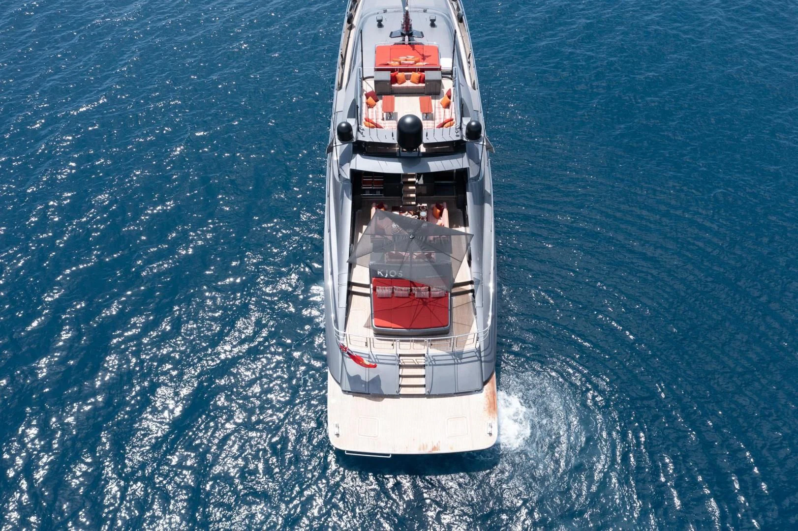 a white and red ship in a bottle aboard KJOS Yacht for Charter