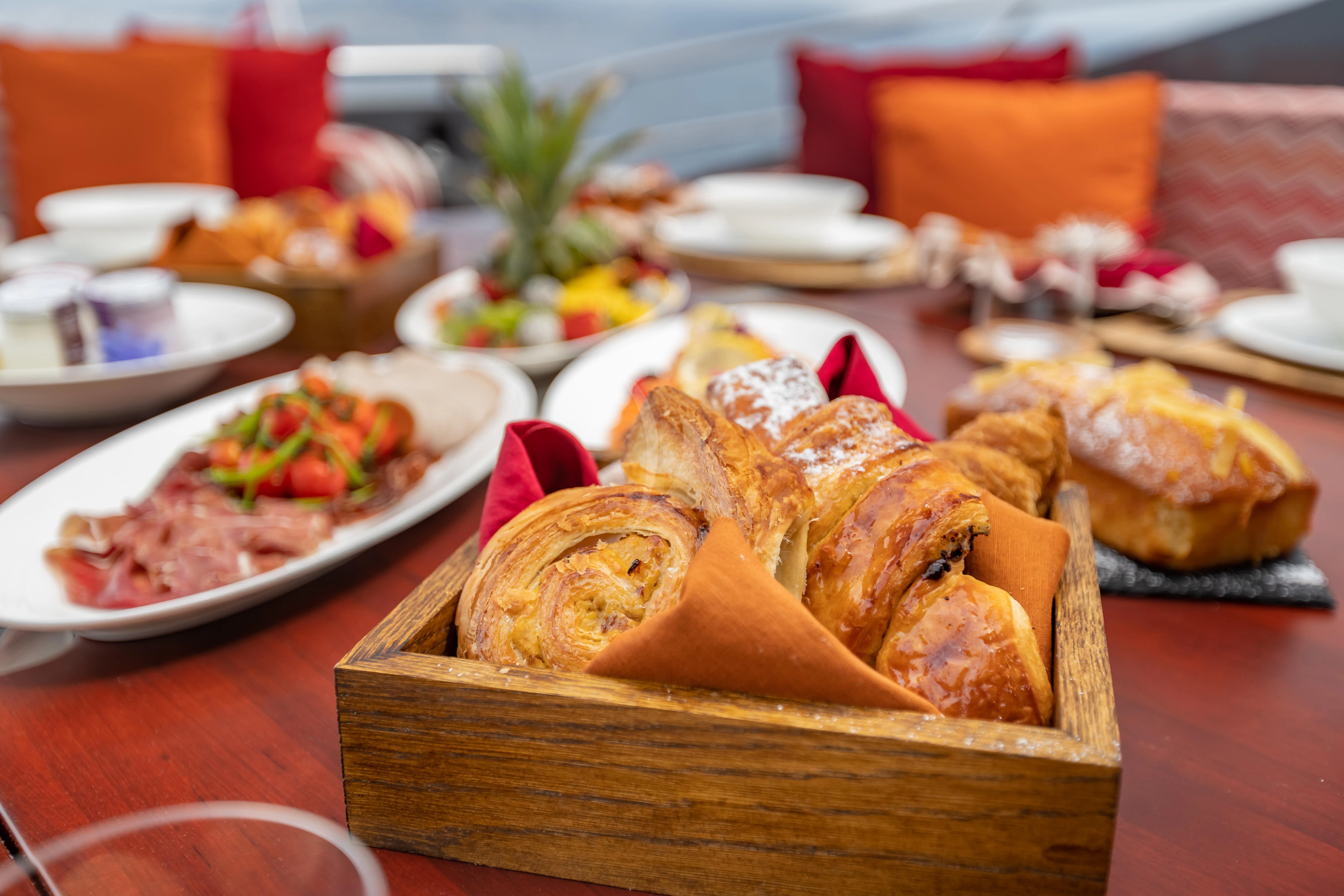 a table full of food aboard KJOS Yacht for Charter