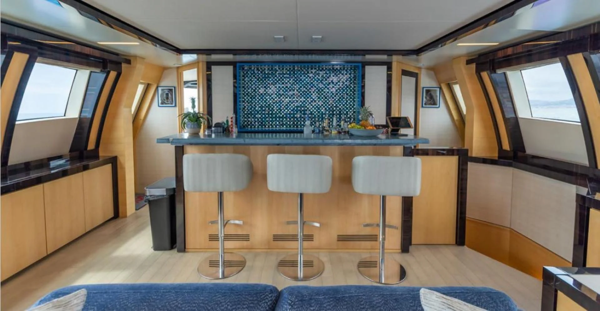 a kitchen with stools and a bar aboard KJOS Yacht for Charter
