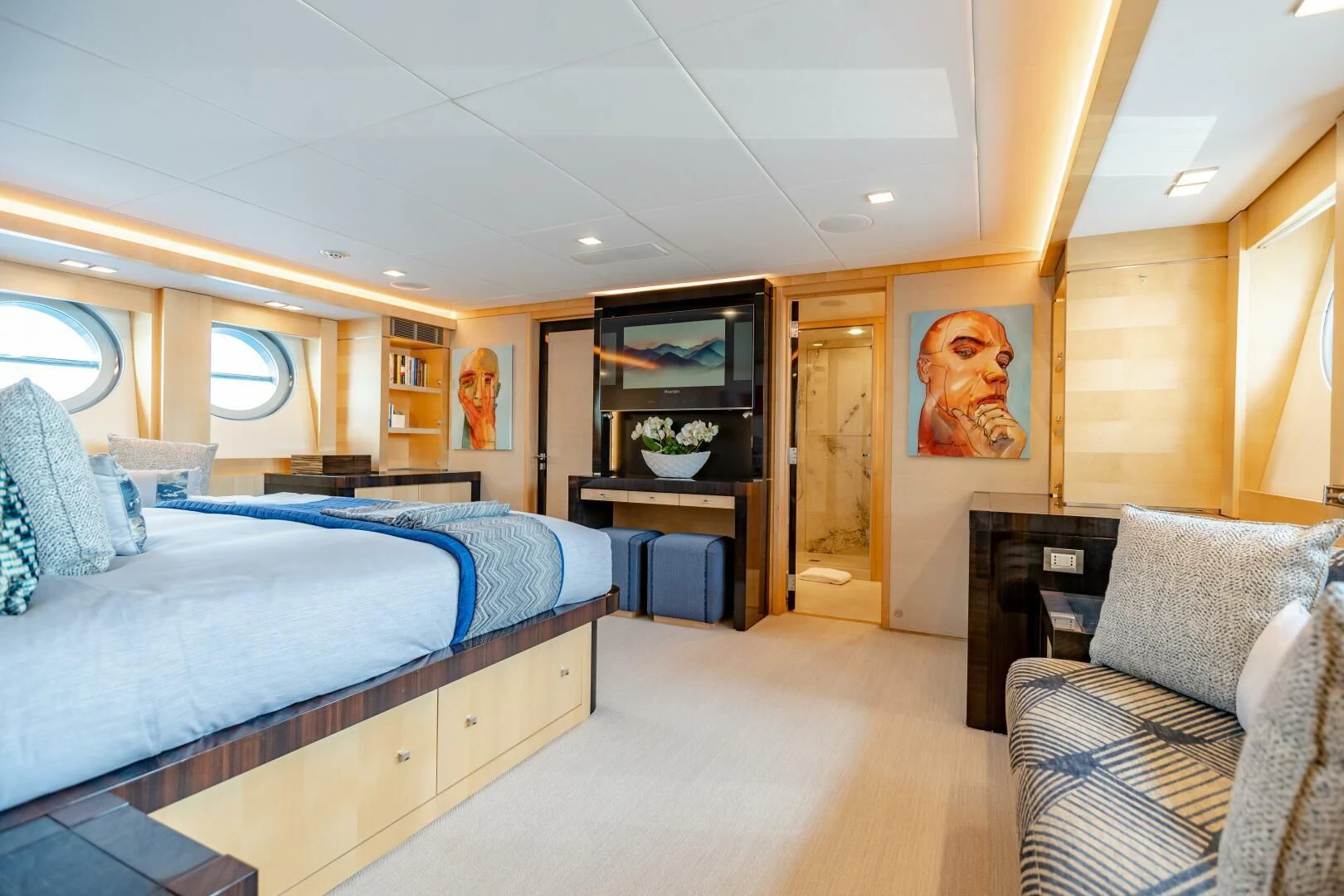 a bedroom with a bed and a chair aboard KJOS Yacht for Charter